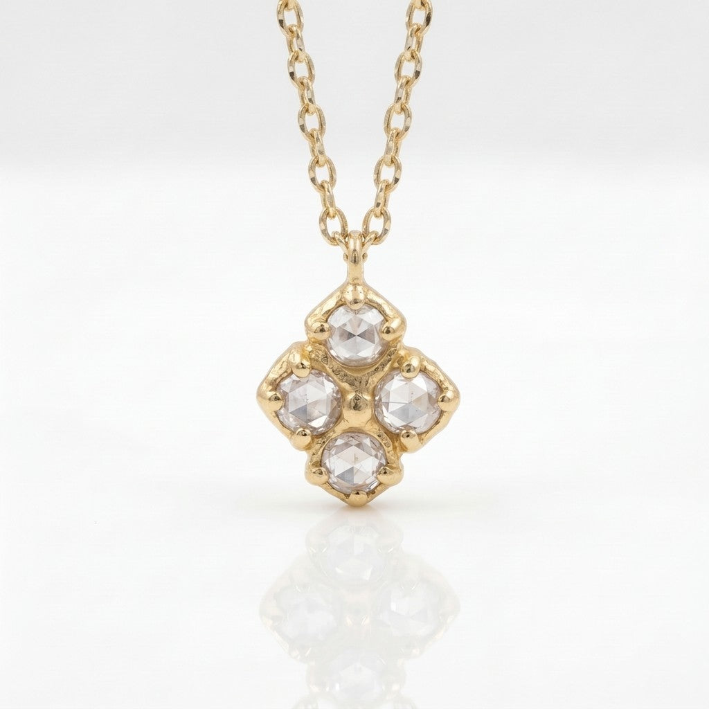 Gold necklace with a diamond pendant on a white background