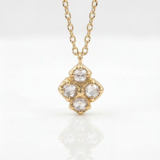 Gold necklace with a diamond pendant on a white background