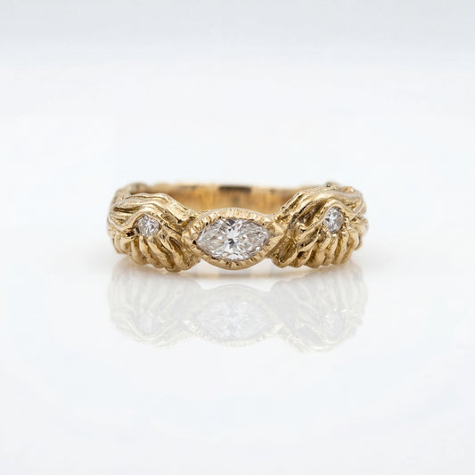Gold ring with diamond accents on a white background