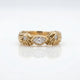 Gold ring with diamond accents on a white background