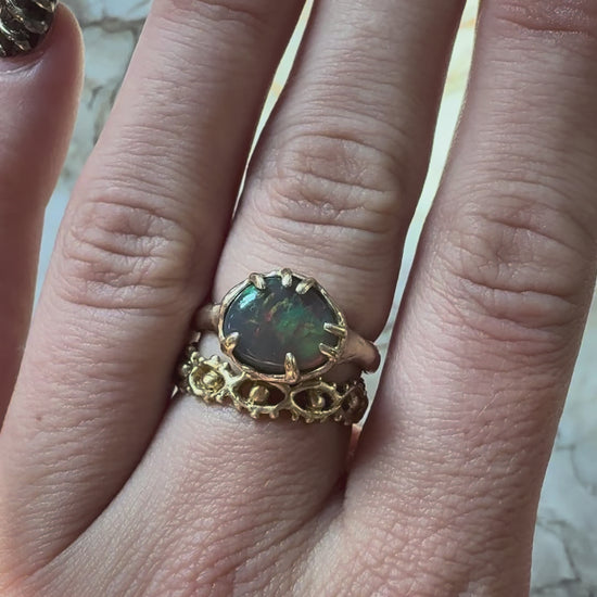 Opal ring with eye ring below hitting light