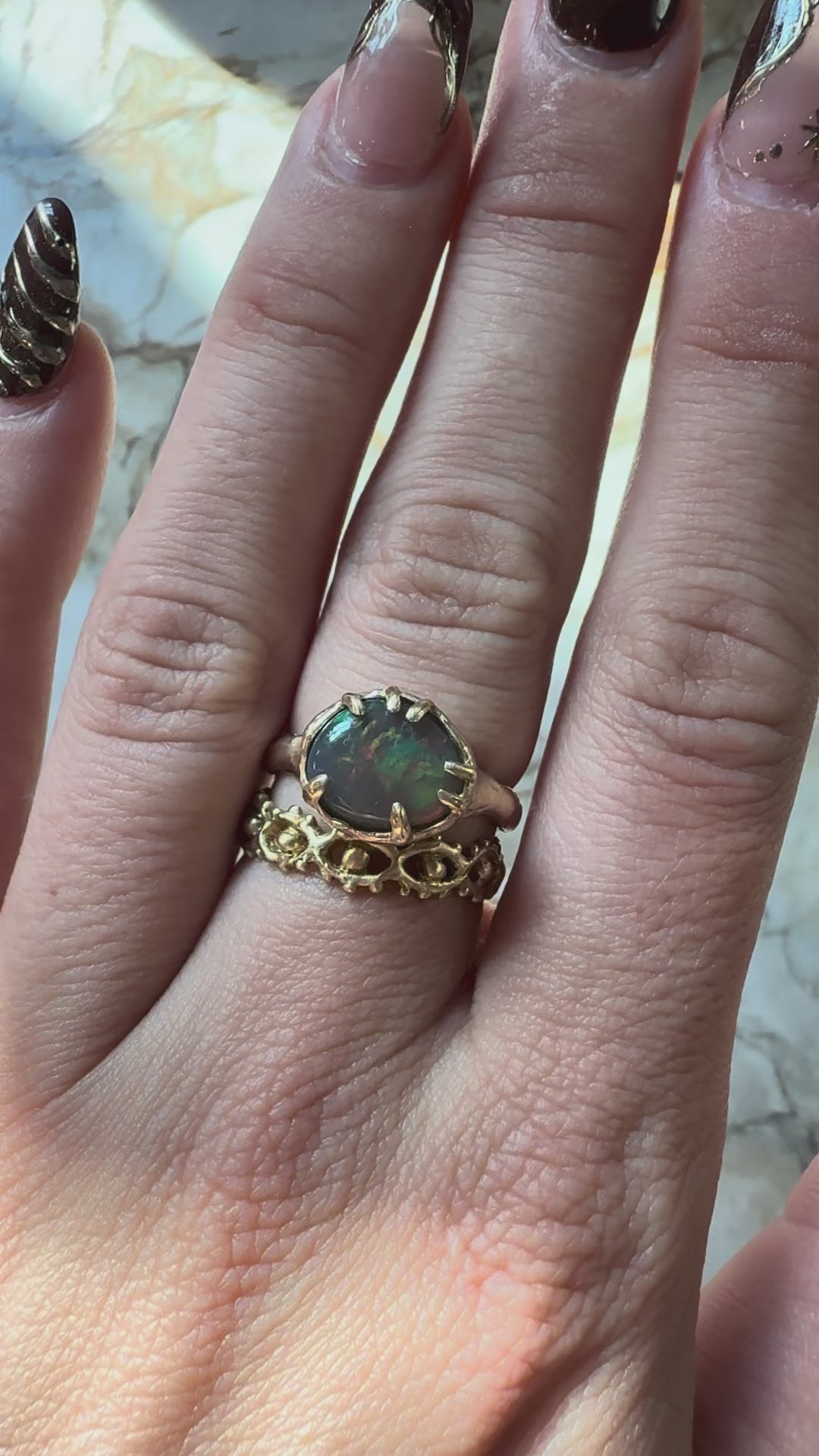 Opal ring with eye ring below hitting light
