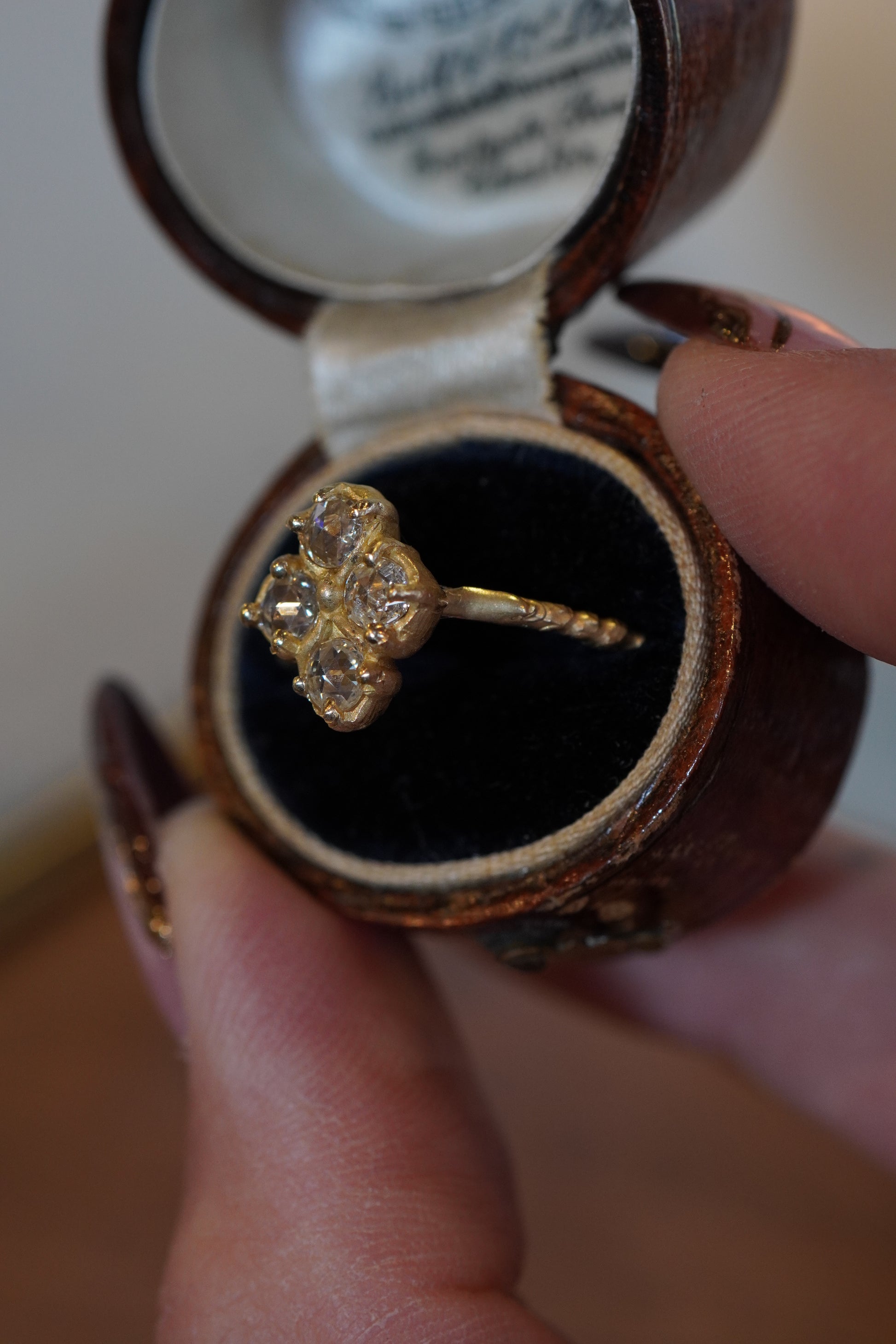 gold ring with diamonds in antique box